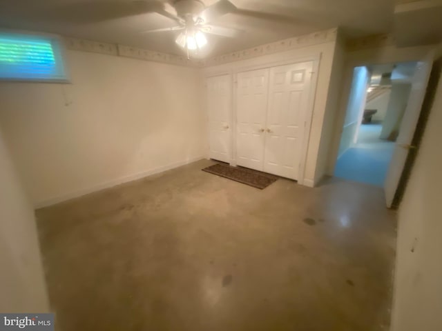 interior space featuring ceiling fan, baseboards, and a closet