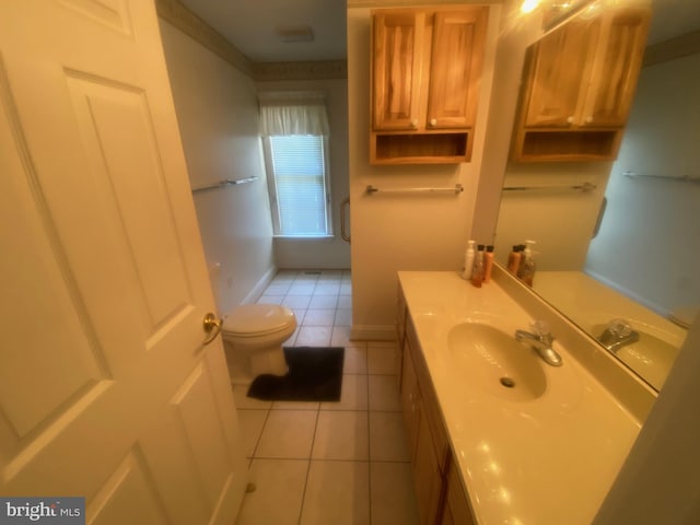 bathroom featuring tile patterned flooring, baseboards, vanity, and toilet