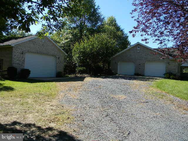 exterior space featuring a detached garage and an outdoor structure