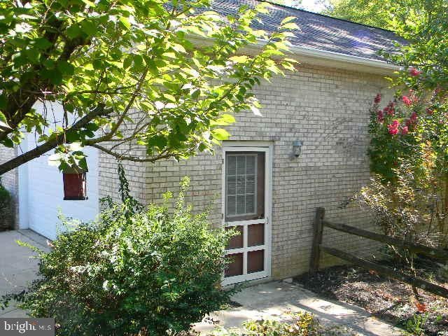 view of side of home with brick siding