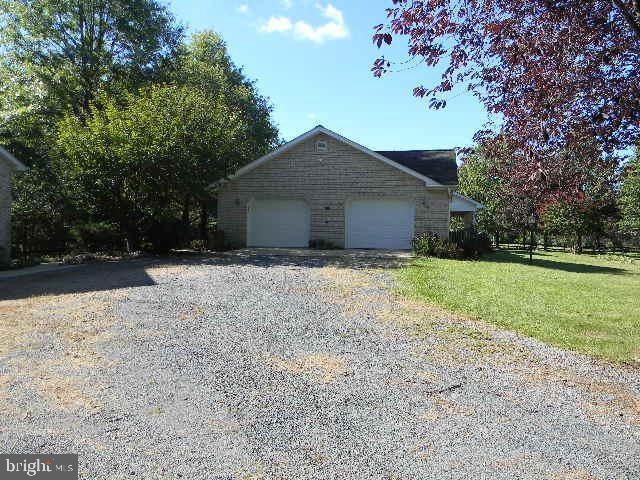 view of front of property featuring a garage and a front lawn