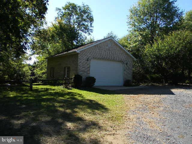 detached garage featuring fence