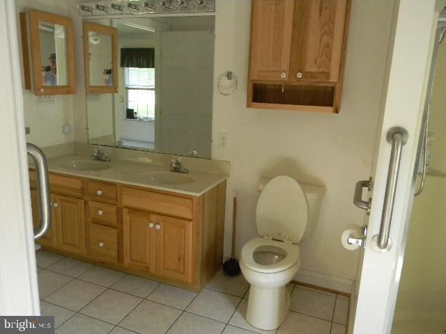 bathroom with tile patterned floors, toilet, and vanity