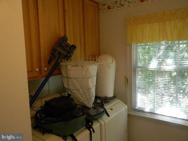 washroom with cabinets and independent washer and dryer