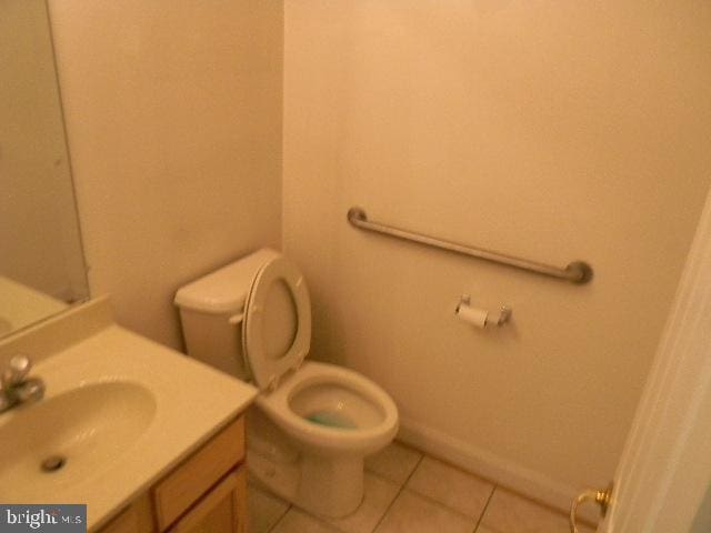 bathroom featuring vanity, toilet, and tile patterned floors