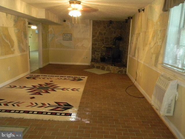 hall with brick floor and baseboards