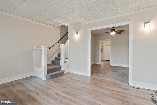 interior space with crown molding, hardwood / wood-style floors, and ceiling fan