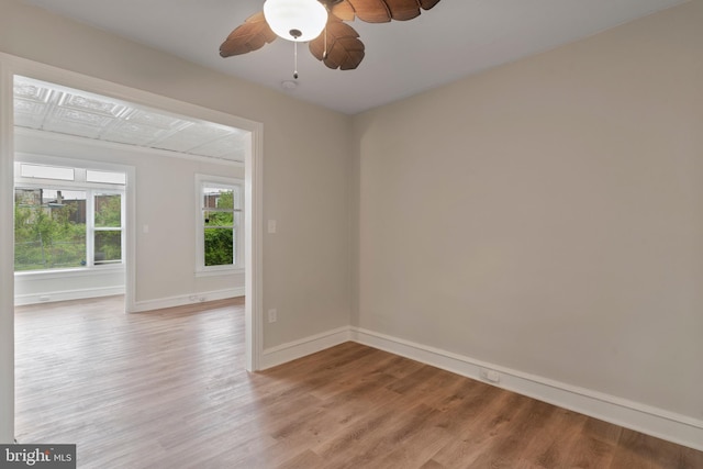 empty room with light hardwood / wood-style flooring and ceiling fan