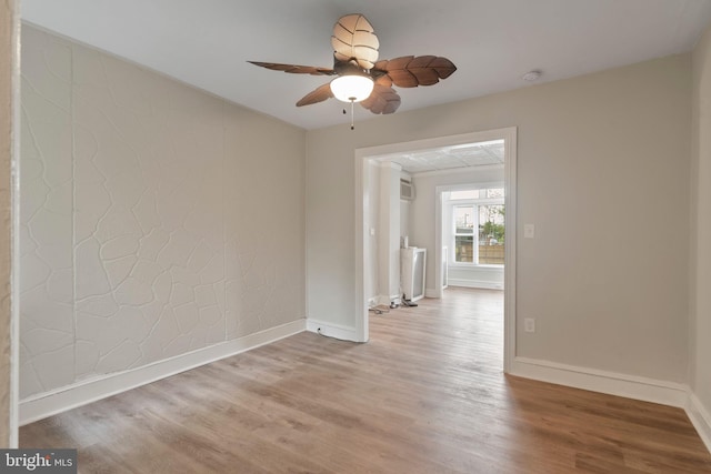 spare room with light hardwood / wood-style flooring and ceiling fan