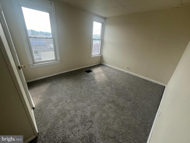 carpeted empty room featuring a healthy amount of sunlight