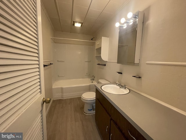 full bathroom featuring vanity, toilet, wood-type flooring, and washtub / shower combination