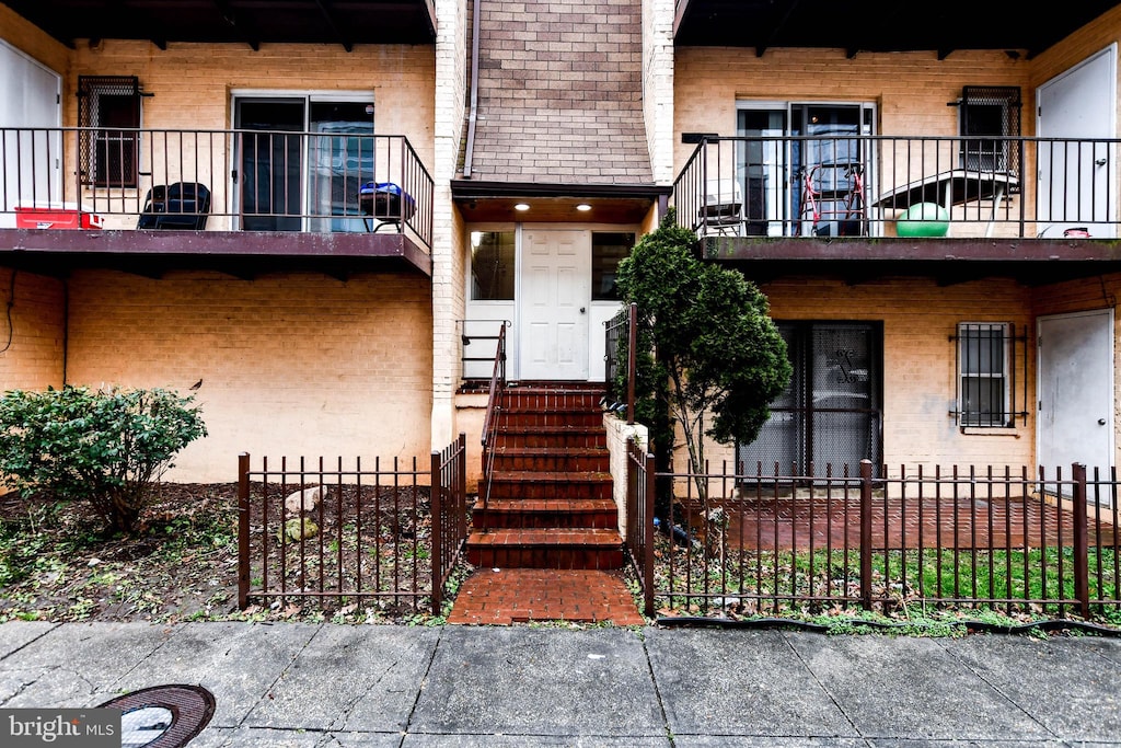 view of exterior entry featuring a balcony