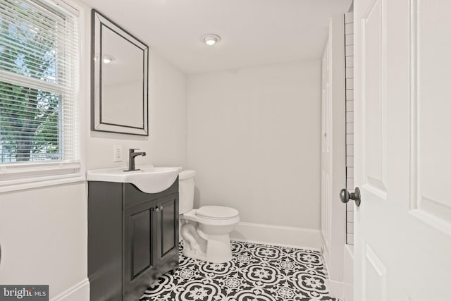 bathroom with vanity, toilet, and tile patterned floors