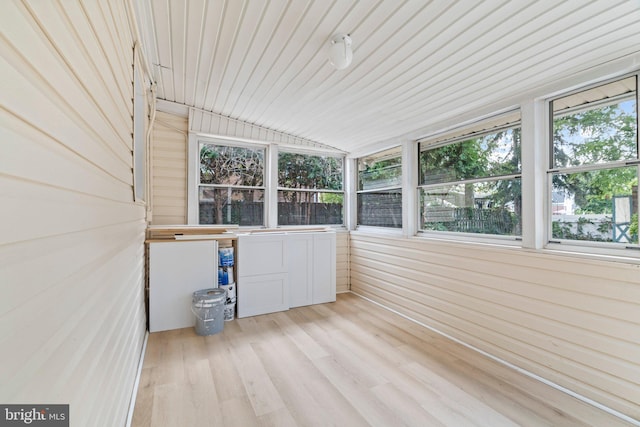 unfurnished sunroom with vaulted ceiling and wood ceiling