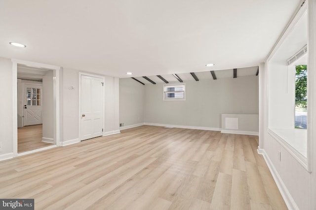 additional living space featuring light wood-type flooring and plenty of natural light