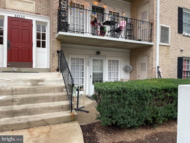 doorway to property featuring brick siding