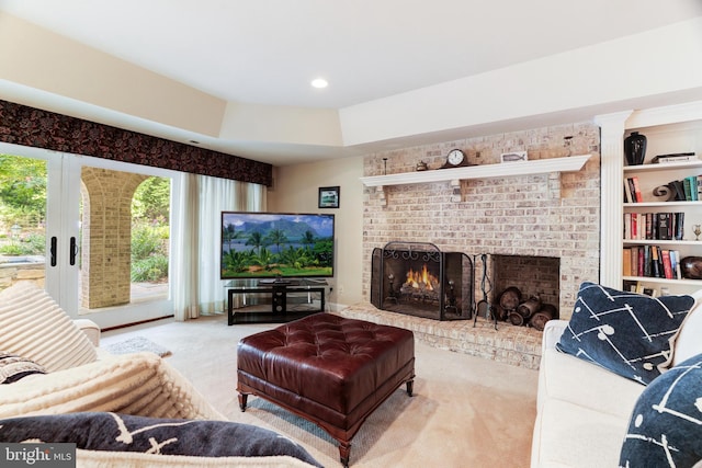 carpeted living room featuring a brick fireplace