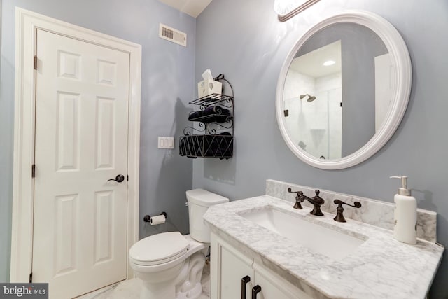 bathroom with a shower, vanity, and toilet