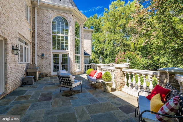 view of patio featuring an outdoor living space and a grill