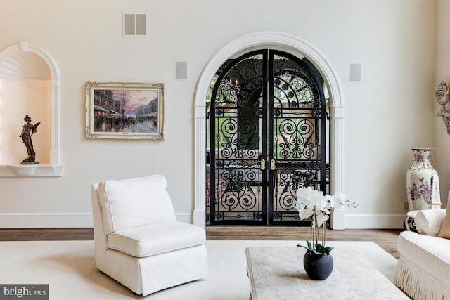 sitting room featuring light hardwood / wood-style flooring and french doors