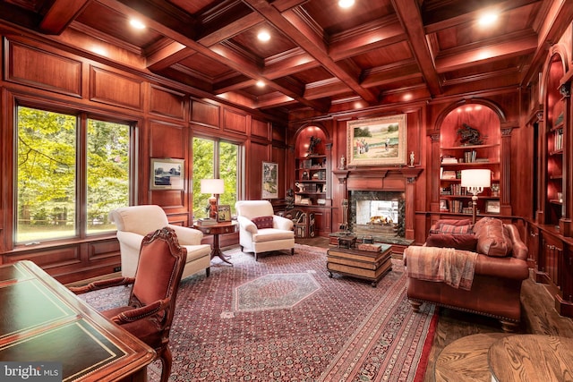 sitting room featuring coffered ceiling, a fireplace, wood walls, and beam ceiling