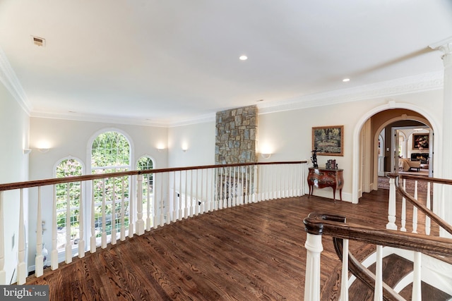 corridor featuring wood-type flooring and crown molding