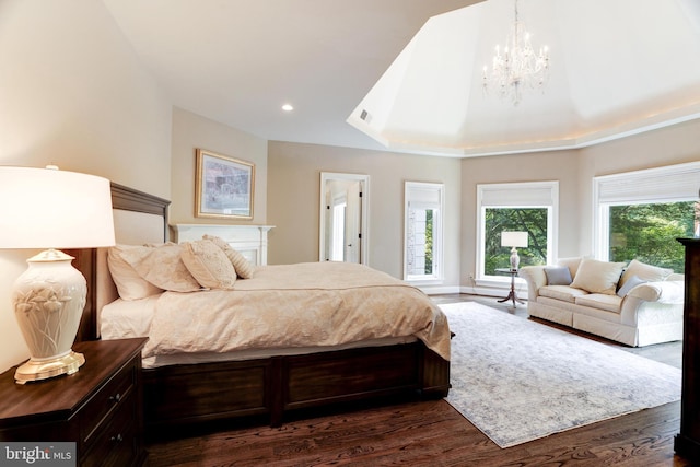 bedroom featuring a notable chandelier and dark wood-type flooring