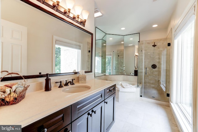 bathroom with vanity and separate shower and tub