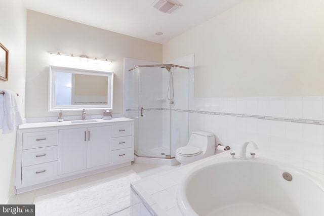 full bathroom featuring shower with separate bathtub, vanity, toilet, and tile patterned floors