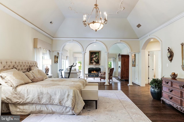 bedroom featuring a notable chandelier, lofted ceiling, decorative columns, and dark hardwood / wood-style flooring