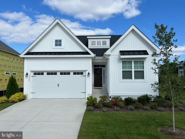 view of front of home with a garage and a front lawn