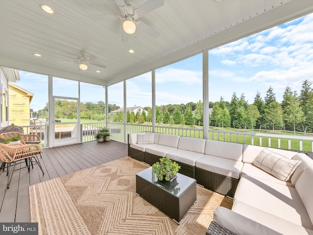 sunroom / solarium with a ceiling fan