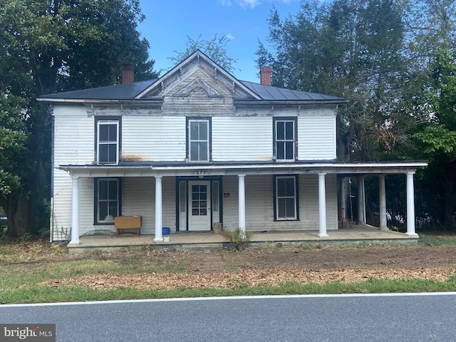 view of front of property with covered porch and a chimney