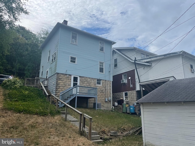 rear view of property with a wooden deck and central air condition unit