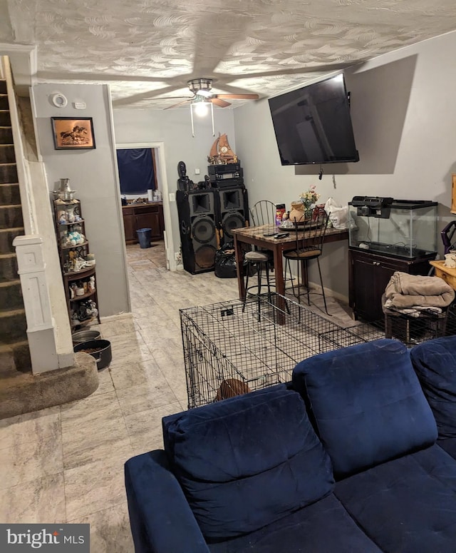 tiled living room with ceiling fan