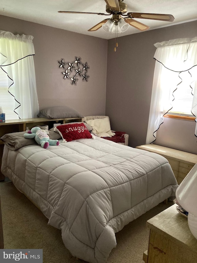 carpeted bedroom with ceiling fan