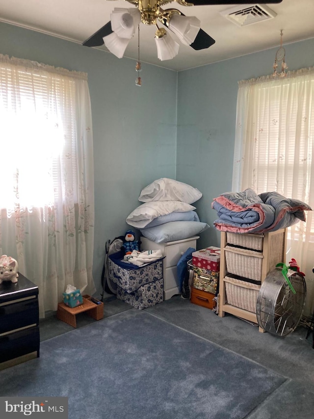 bedroom with ceiling fan and dark colored carpet