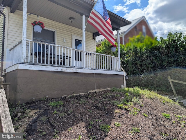 view of side of home featuring a porch