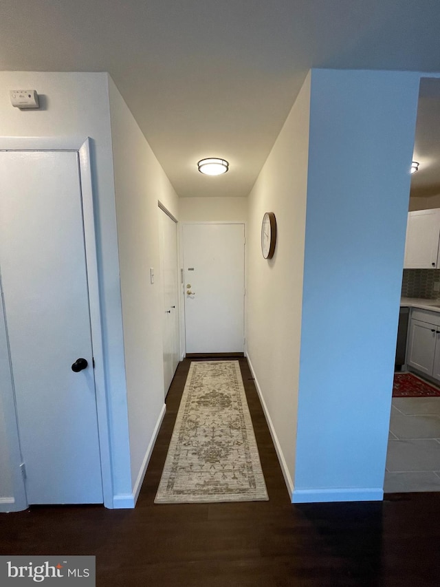 hallway featuring dark hardwood / wood-style flooring