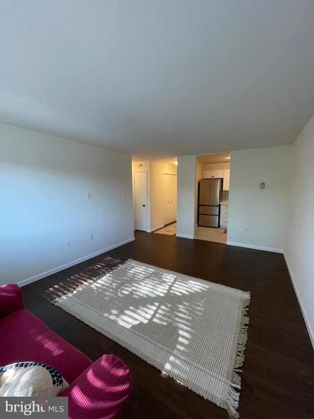 unfurnished living room featuring dark hardwood / wood-style flooring