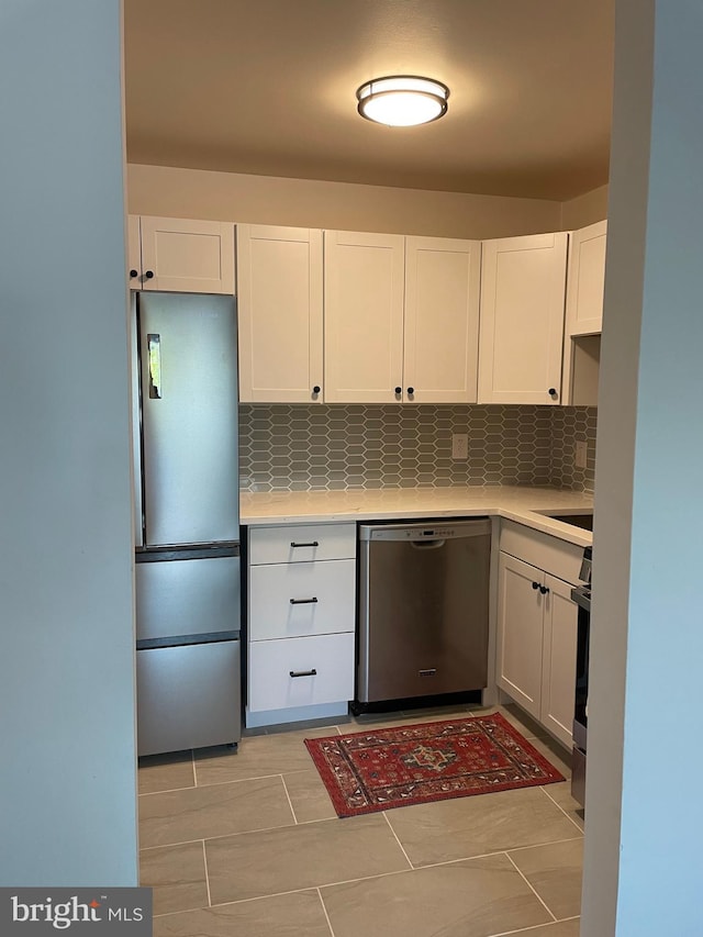 kitchen featuring white cabinets, backsplash, and stainless steel appliances