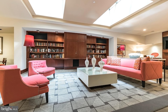 living area featuring a skylight and built in features