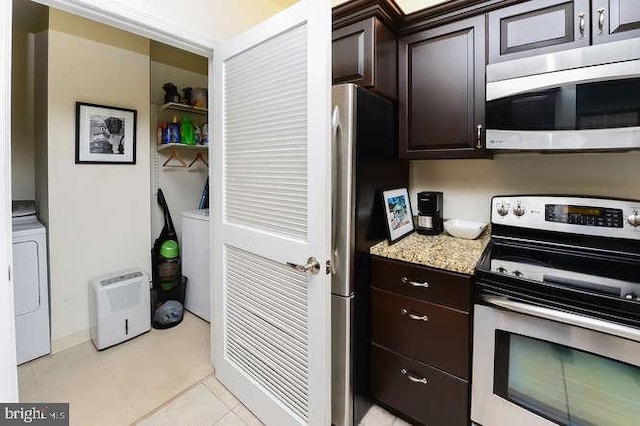 kitchen with light tile patterned floors, dark brown cabinets, washer / clothes dryer, and stainless steel appliances