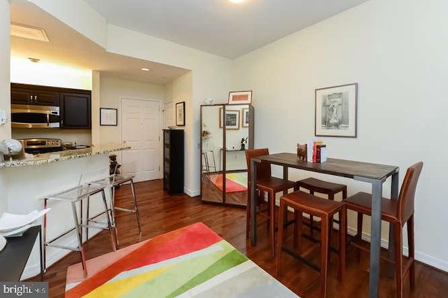 dining room featuring baseboards and dark wood-style flooring