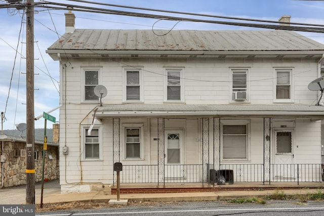 view of front of property featuring cooling unit and a porch