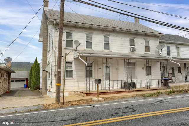 view of front facade with cooling unit and covered porch