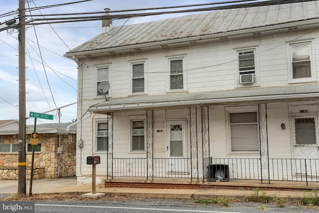 view of front of house featuring cooling unit and a porch