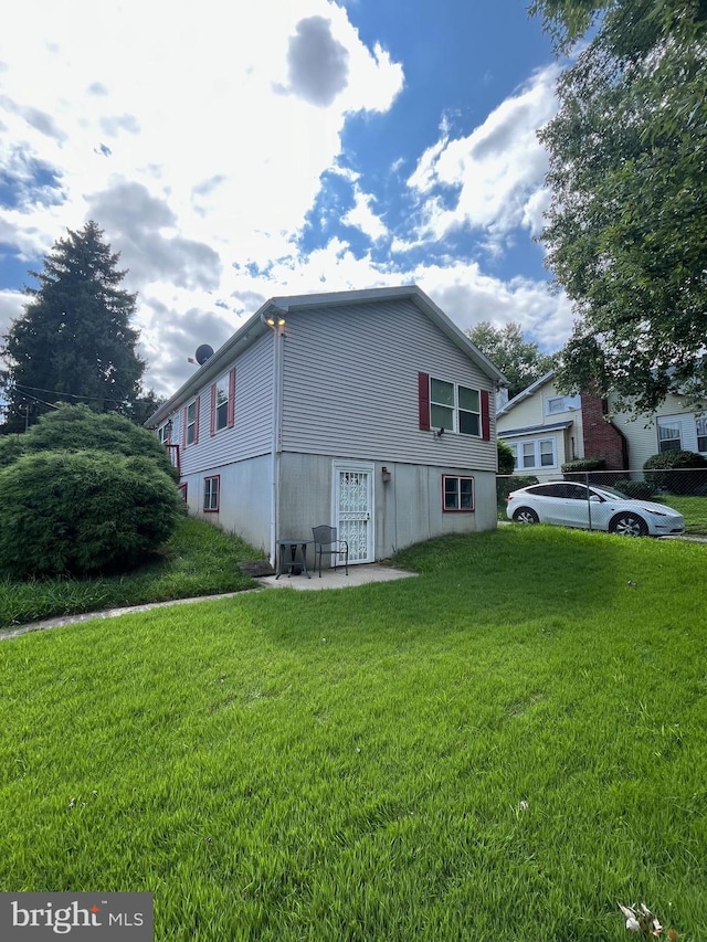 view of home's exterior featuring a yard and a patio