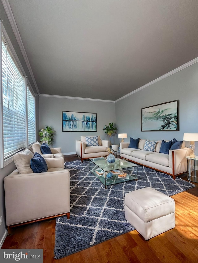 living area with ornamental molding, dark wood-style flooring, and baseboards