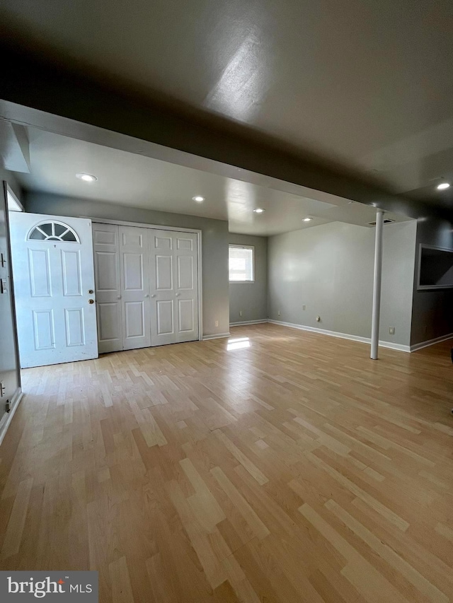 basement with light wood-style flooring, baseboards, and recessed lighting